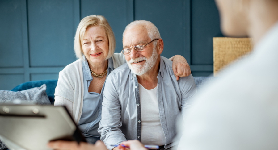 Couple Looking At Computer With Estate Planning Advisor