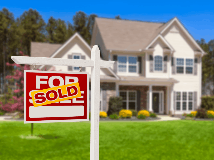 Home for sale with a sold sign in front.